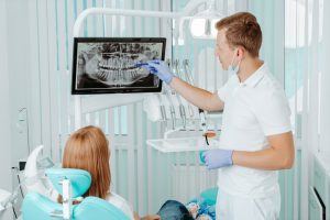 dentist showing patient X-rays